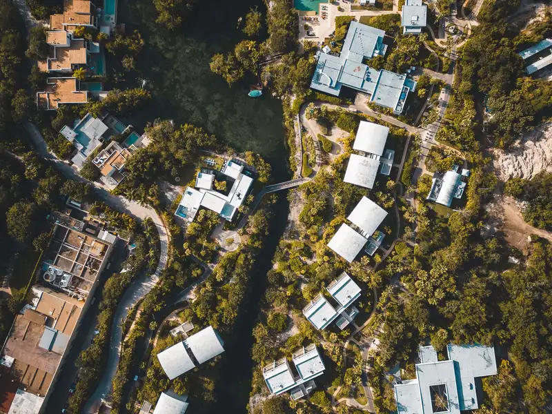 Stunning aerial view of a tropical resort in Playa del Carmen, showcasing lush greenery and vibrant architecture.